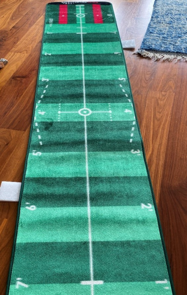 To help reach her goals, Sandy has a putting green in her living room.